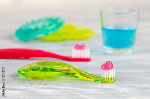 children s toothbrush oral care on wooden background