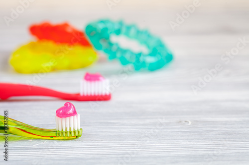 children s toothbrush oral care on wooden background