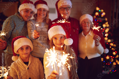 family spending time together with sparklers celebrating Christm