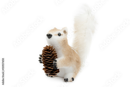 Cute little squirrel with cone. Winter, Christmas, New Year decoration. Decorative squirrel - children's room, interior, home decor. Isolated on white background. Side view. Closeup.