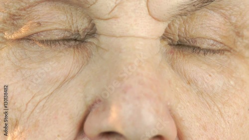 Old woman's face with tired expression of face. Close up photo