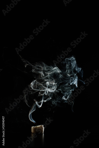 Slow blowing off candle in the dark