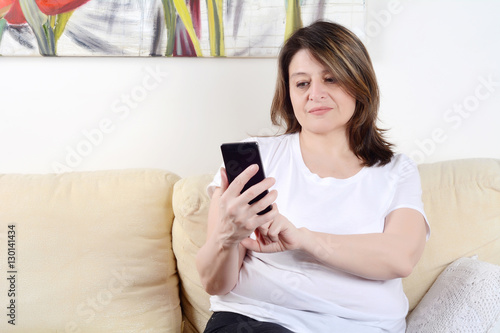 Woman sending messages with smartphone.