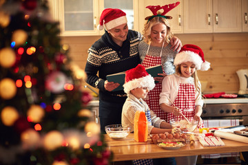 children and parents preparing cookies for Xmas.