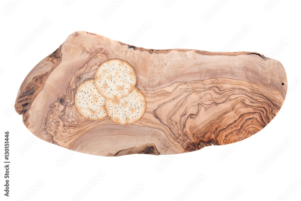 Obraz premium Wheat crackers on olive wood cutting board isolated on white background