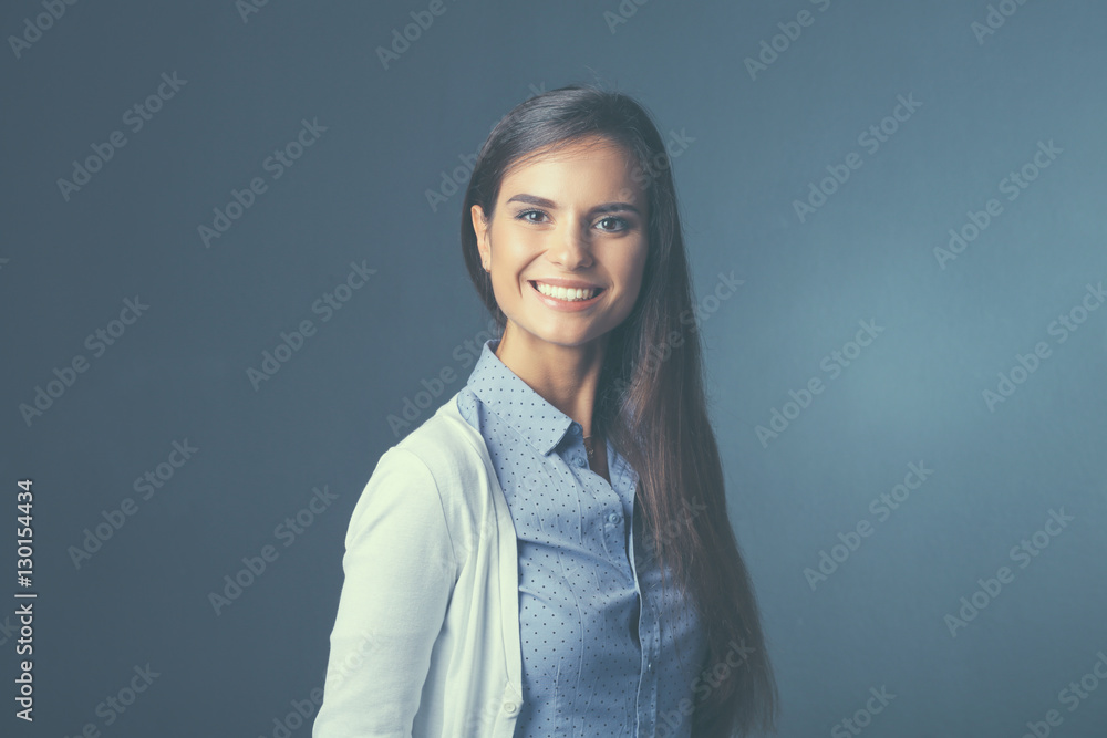 Portrait of a businesswoman , against dark background Portrait of a businesswoman , against dark background