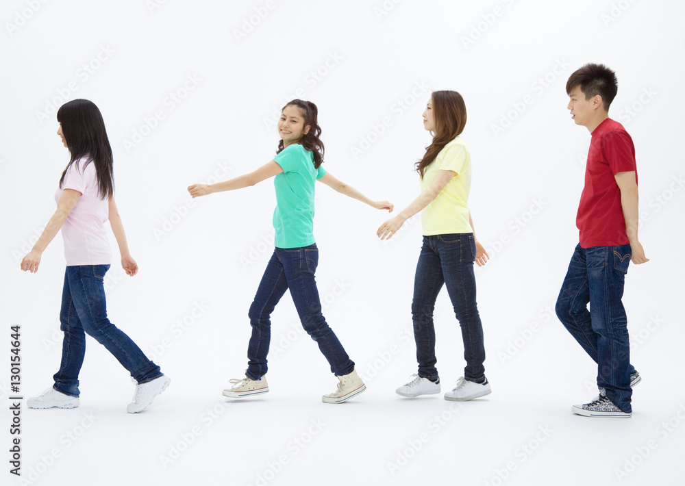 Fototapeta premium Young men and women walking in a row