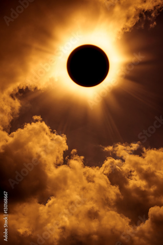 Natural phenomenon. Solar eclipse space with cloud on gold sky background.