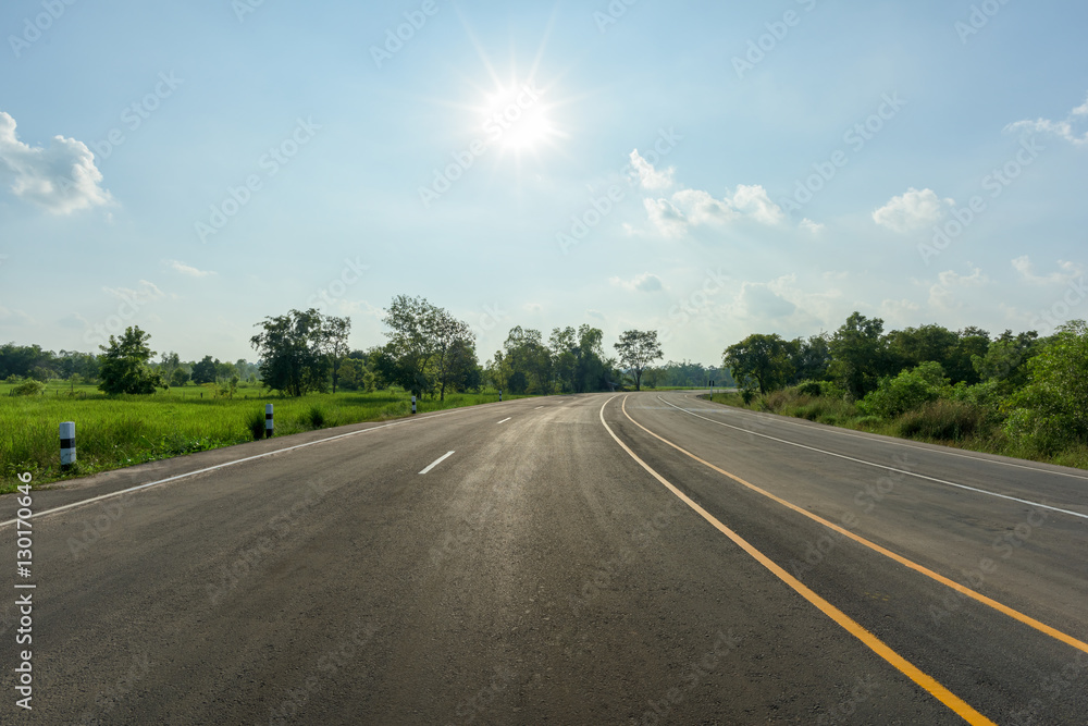asphalt road and sun on blue sky
