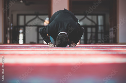 Young beautiful Muslim Man Praying In Mosque