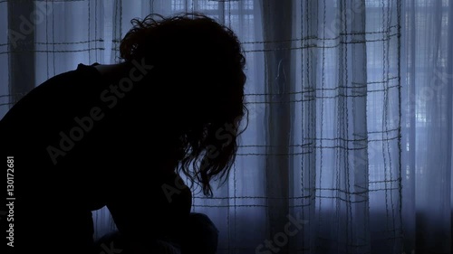 frantic womas sat in a room with closed tents seems to blame herself