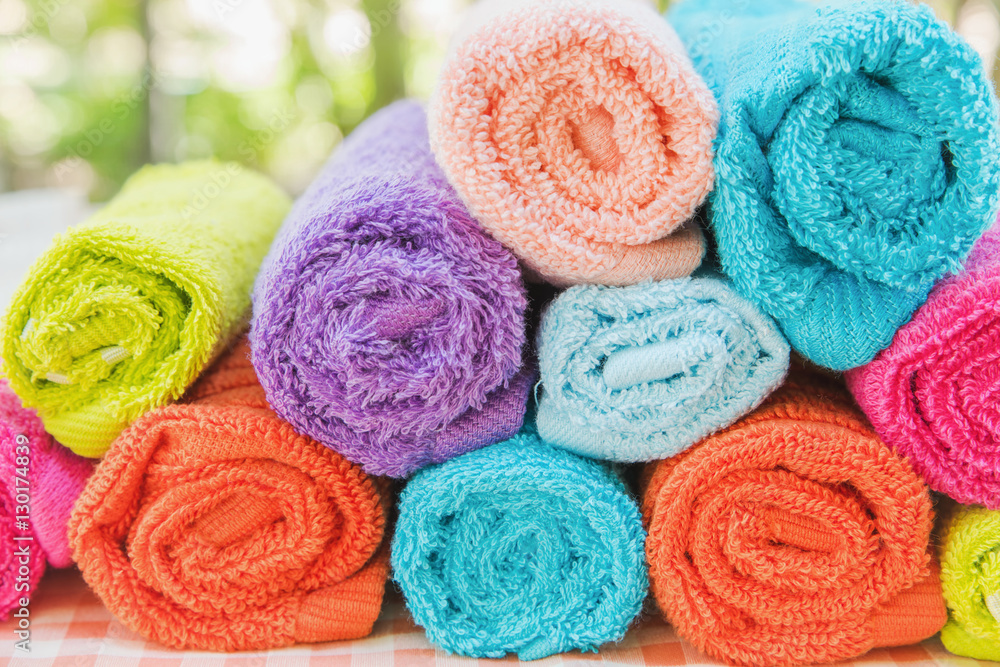 Closeup multicolor towels with nature blur background at the spa club Closeup multicolor towels with nature blur background at the spa club