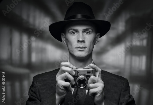 Front view of man holding vintage camera