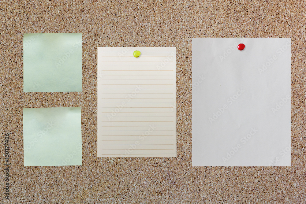 blank paper on corkboard with red and yellow pin