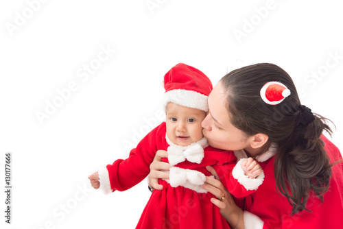 Mother and baby in santa costume christmas celebration
