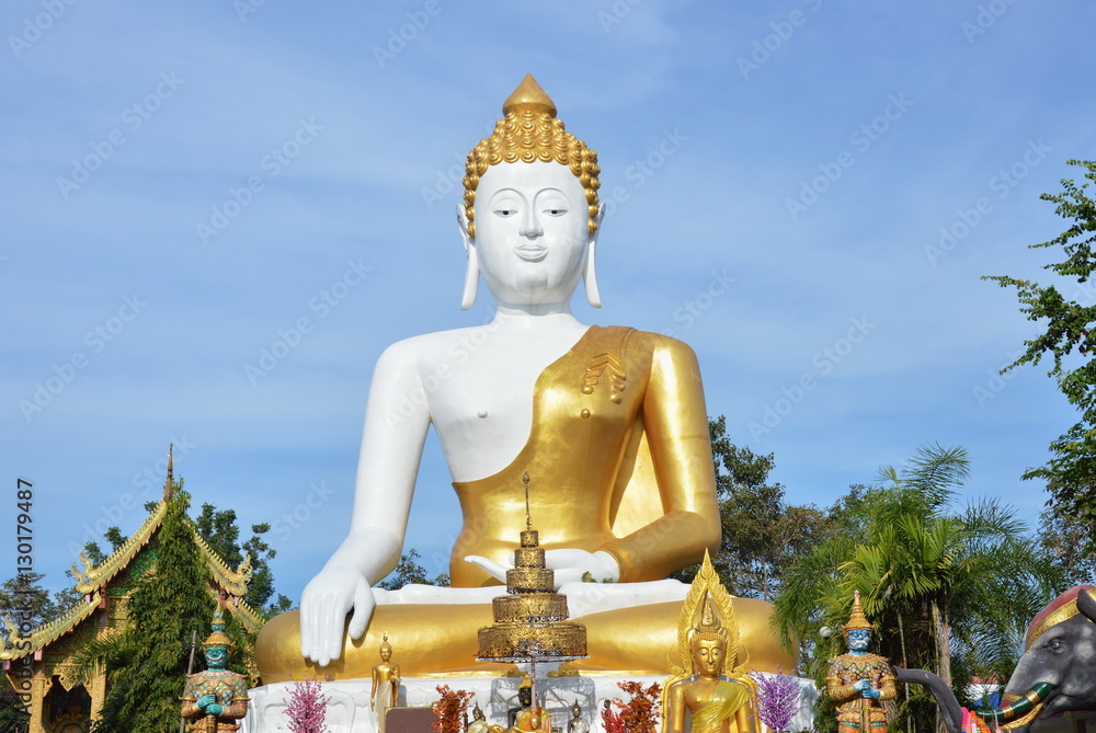 holy big white Buddha image in Wat Phrathat Doi Kham ancient temple in Thailand holy big white Buddha image in Wat Phrathat Doi Kham ancient temple in Thailand