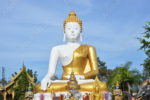 holy big white Buddha image in Wat Phrathat Doi Kham ancient temple in Thailand