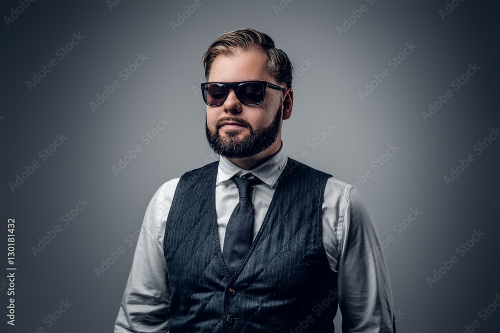 An elegant bearded business man in sunglasses. An elegant bearded business man in sunglasses.