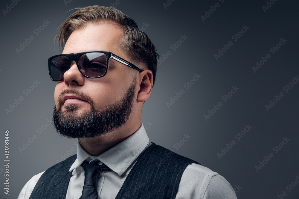 Bearded male in sunglasses wearing waistcoat and bow tie. Bearded male in sunglasses wearing waistcoat and bow tie.