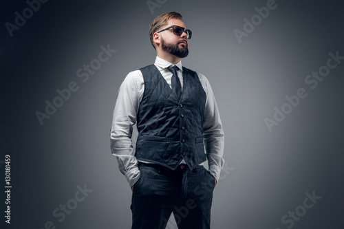 An elegant bearded business man in sunglasses.