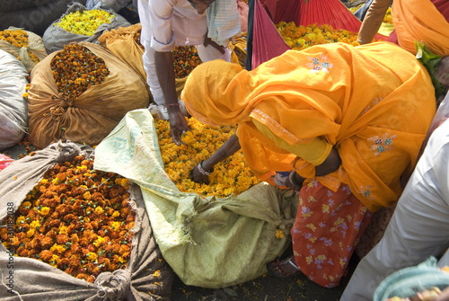 Woman buying marigolds, flower market, Bari Chaupar, Jaipur, Rajasthan photo