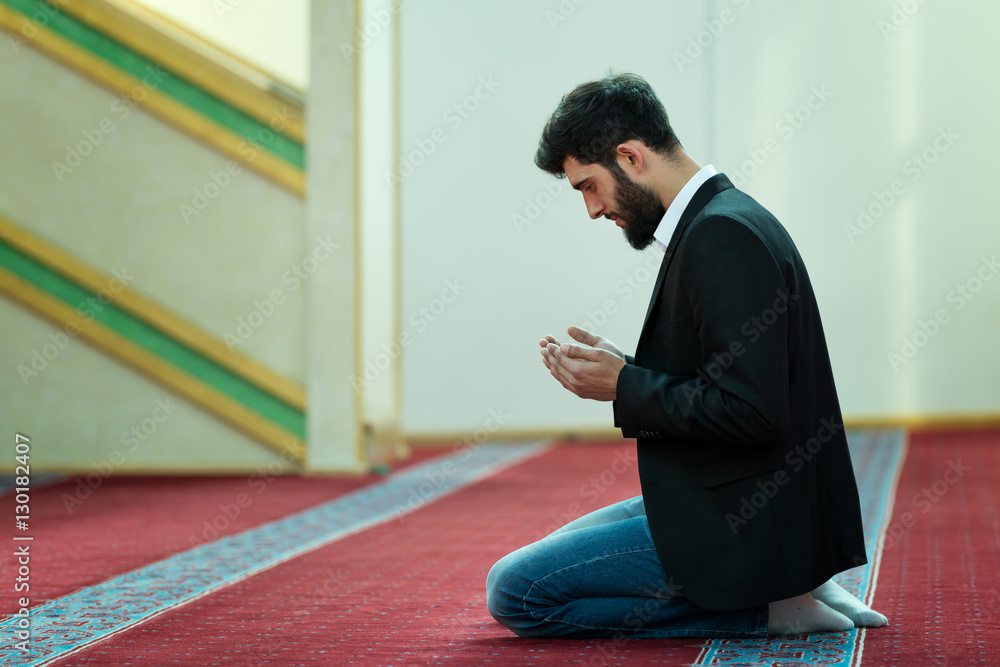 Fototapeta premium Young beautiful Muslim Man Praying In Mosque