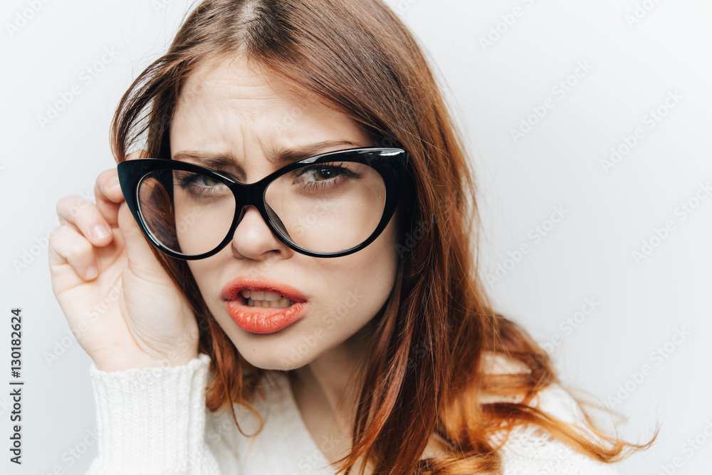 Portrait of a girl in glasses on a light background
Portrait of a girl in glasses on a light background