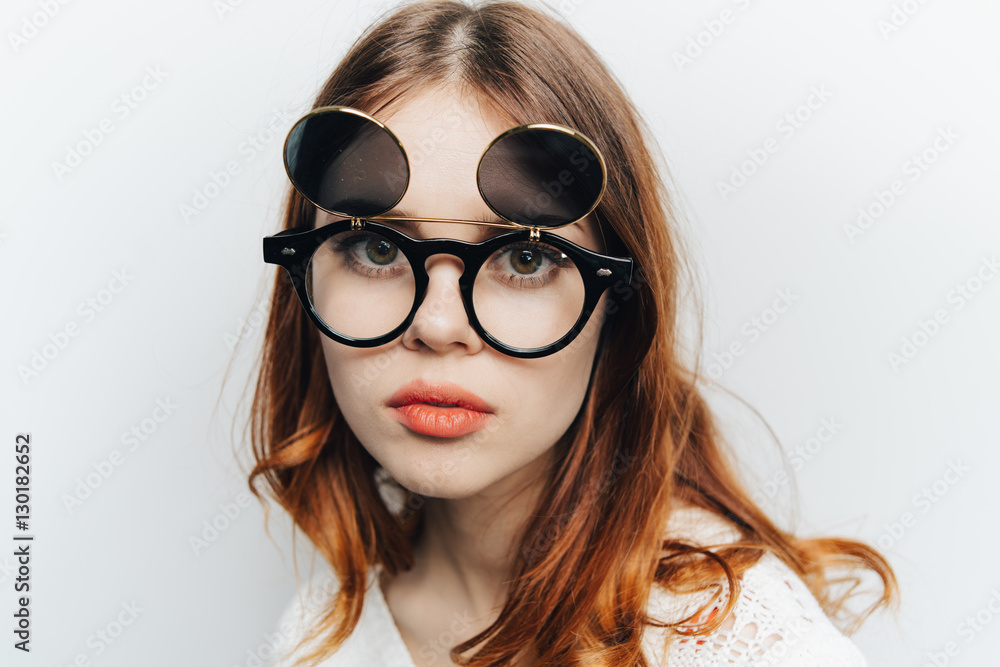 Portrait of a girl in glasses on a light background
Portrait of a girl in glasses on a light background