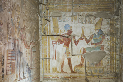 Bas relief of Pharaoh Seti I making an offering to the seated God Horus on right, Temple of Seti I, Abydos, Egypt photo