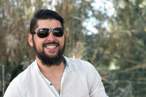 Handsome young man with a beard and glasses.