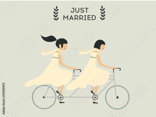 Just married lesbian wedding couple riding bicycle