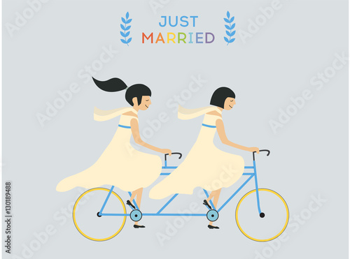 Just married lesbian wedding couple riding bicycle