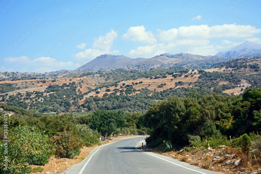Country road leading towards the mountains near Margarites, Crete.