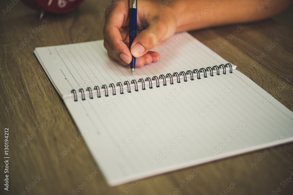 Man hand with pen writing on notebook. Man hand with pen writing on notebook.