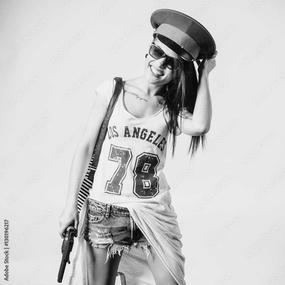 Fashion swag sexy girl holding gun woman having fun wearing police cap  black and white Stock Photo | Adobe Stock