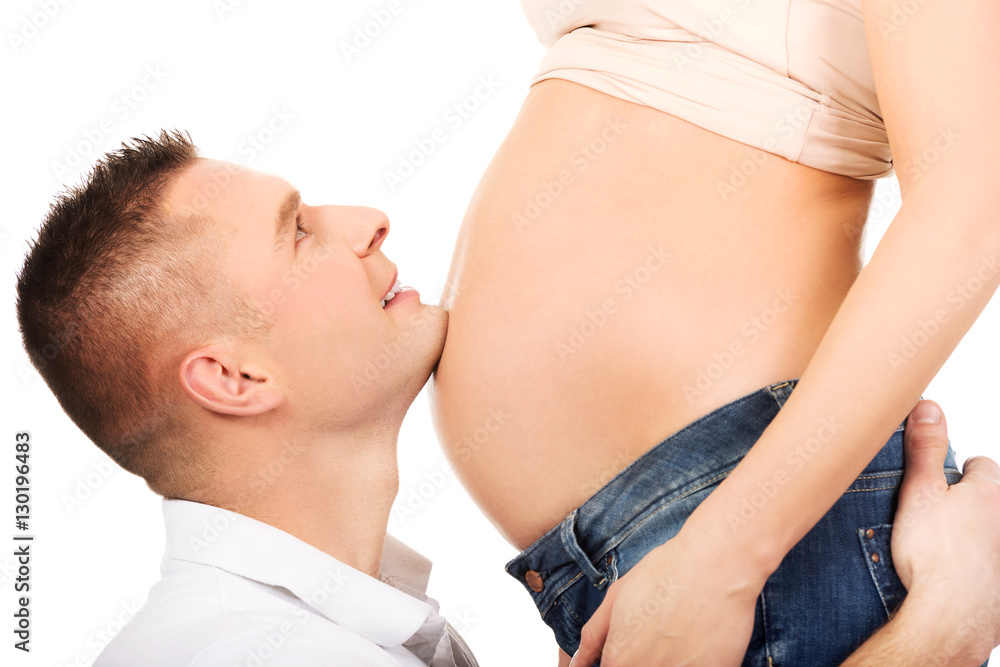 Father embracing mother's pregnant belly Father embracing mother's pregnant belly