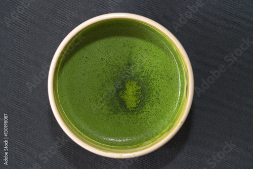 Top view of organic green matcha tea in a bow  