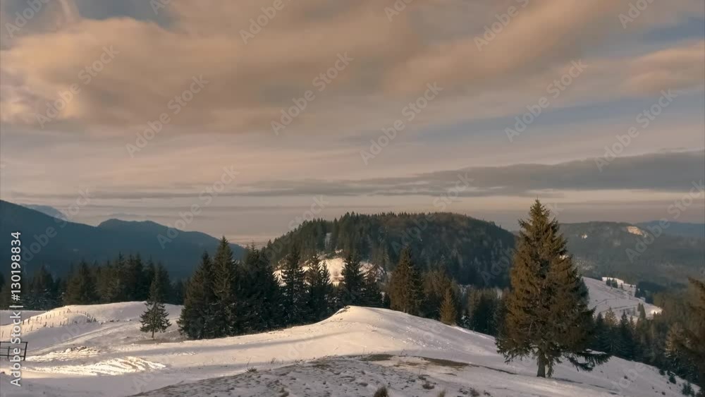 time lapse of sunset in the mountains landscape with clouds over the snow covered pines
time lapse of sunset in the mountains landscape with clouds over the snow covered pines