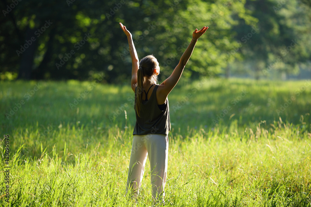 Woman lifts hands to the top in forest Woman lifts hands to the top in forest