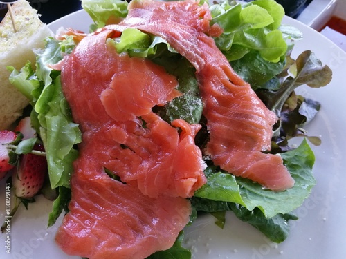 Close-up healthy smoked salmon salad with lettuce and strawberry