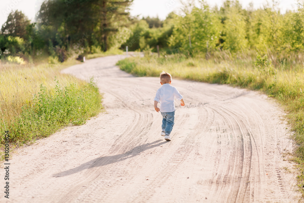 stylish little boy is on his way to his mother stylish little boy is on his way to his mother