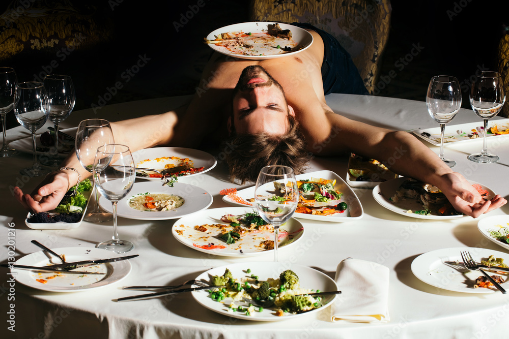Handsome man lying on table StockFoto Adobe Stock