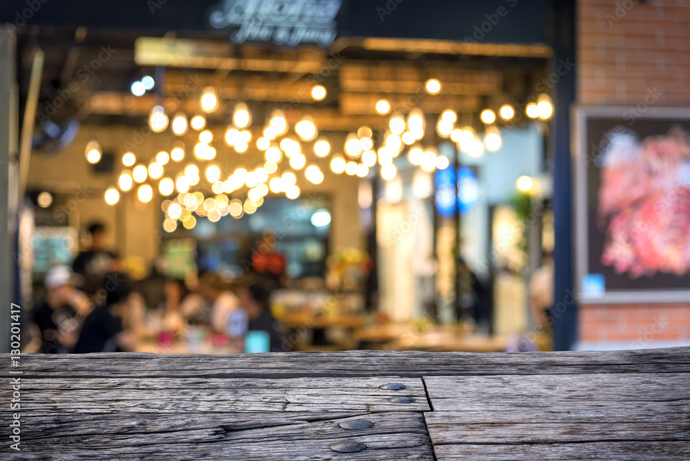 Empty desk foreground and blur coffee shop or cafe restaurant wi Empty desk foreground and blur coffee shop or cafe restaurant wi