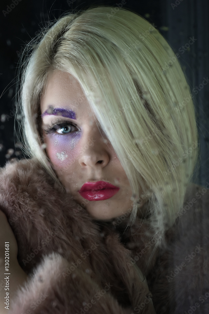 Beautiful young woman looking through glass window with raindrops. Beautiful young woman looking through glass window with raindrops.