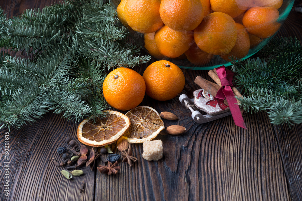 Tangerines in bowl and decorations for the holiday table Tangerines in bowl and decorations for the holiday table