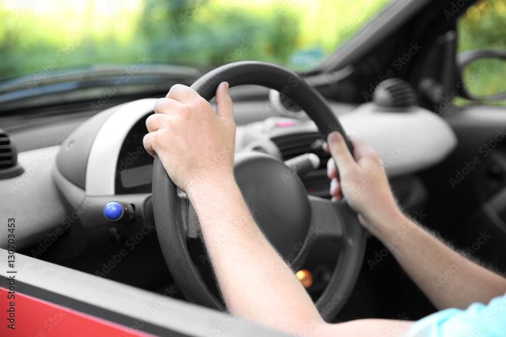 Male hands and steering wheel, closeup