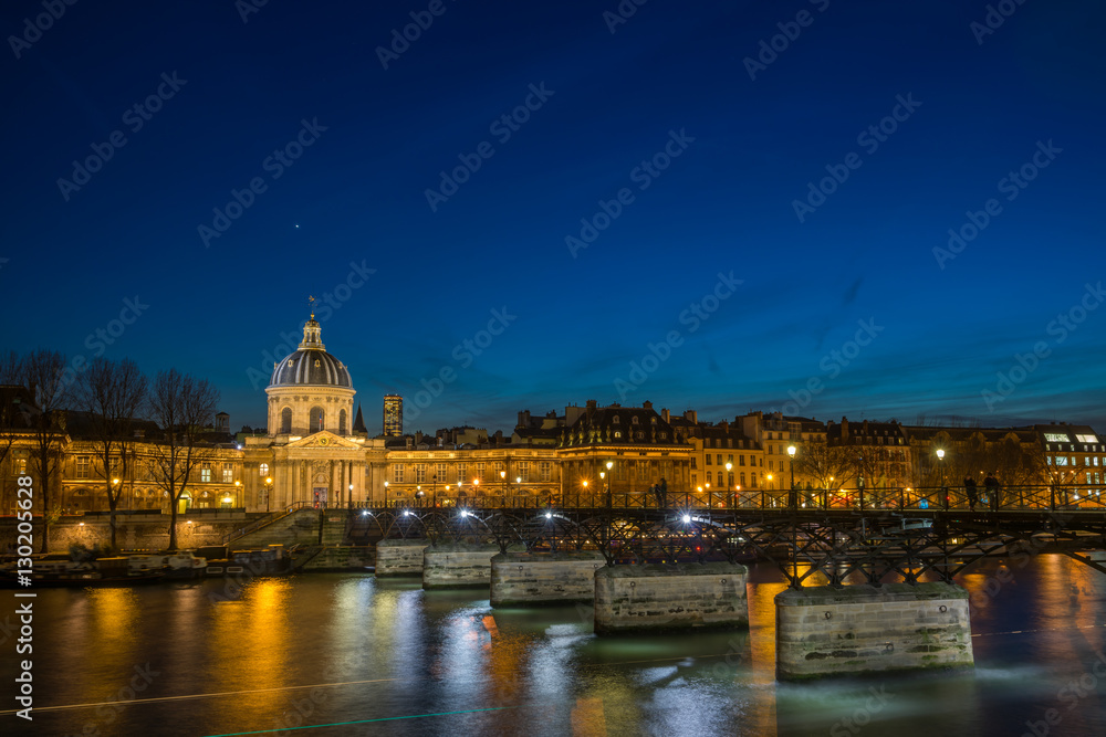 Pont des arts Bridge by the Seine river in Paris at night