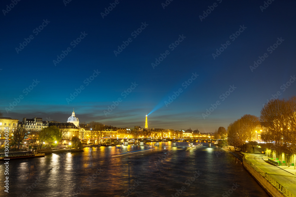Bridge by the Seine river in Paris at night