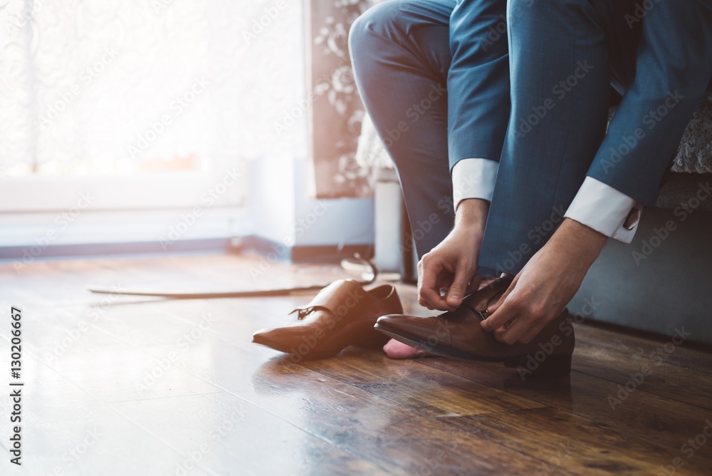 Groom dressing up with classic elegant shoes.