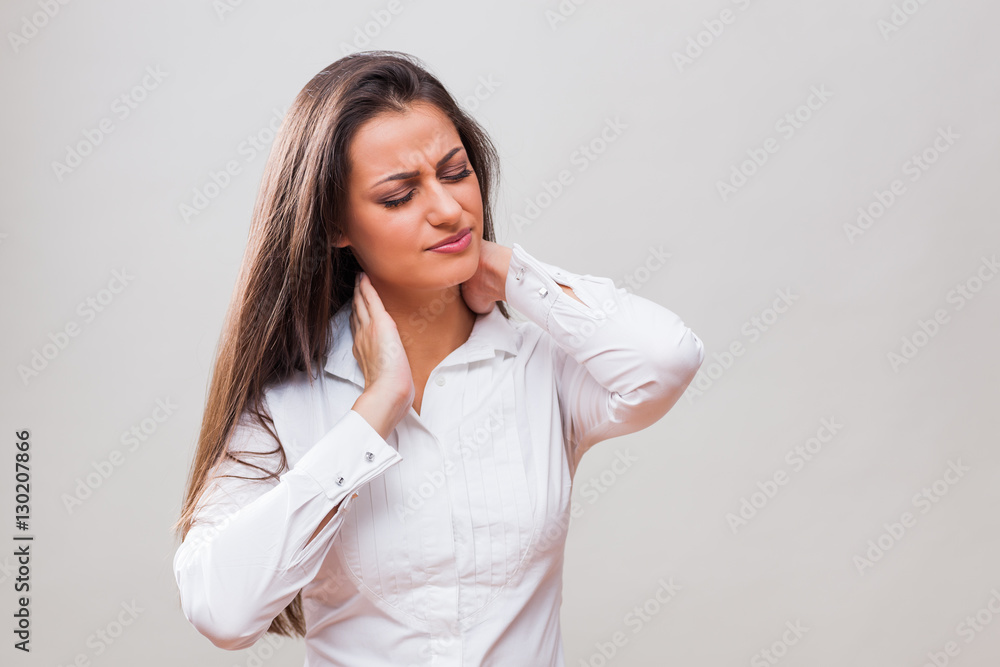 Portrait of young businesswoman who is having pain in her neck. Portrait of young businesswoman who is having pain in her neck.